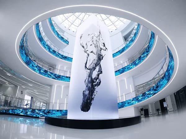Transforming Architectural Spaces with Flexible LED Displays: A Custom Installation Featuring a Central Column and Multi-Level Curved Screens
