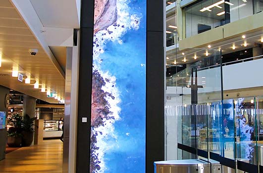 Tall Indoor Transparent Adhesive LED Display Screen Installed on the Glass Facade